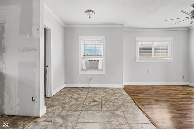 spare room with cooling unit, ornamental molding, a ceiling fan, wood finished floors, and baseboards