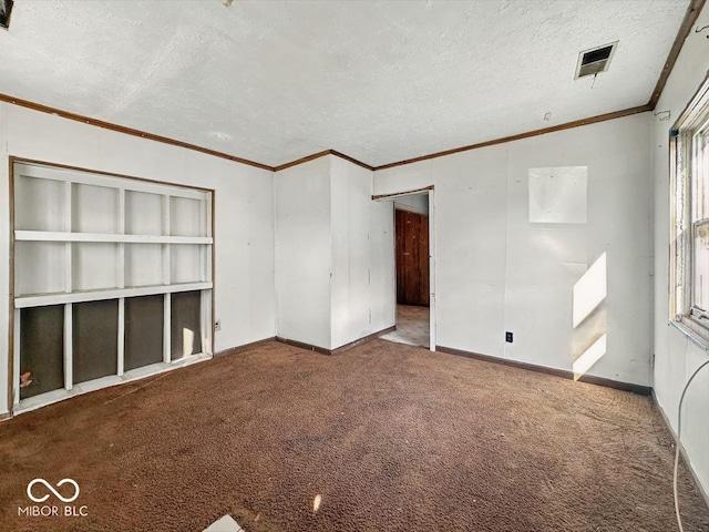 unfurnished room featuring carpet, a textured ceiling, baseboards, visible vents, and ornamental molding