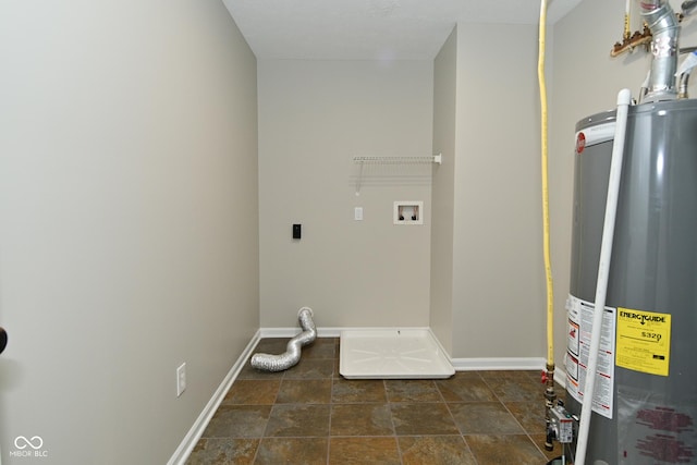 laundry room with gas water heater, baseboards, washer hookup, stone finish floor, and laundry area