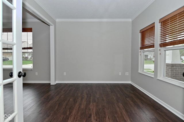 unfurnished room featuring a wealth of natural light, crown molding, baseboards, and dark wood-style flooring