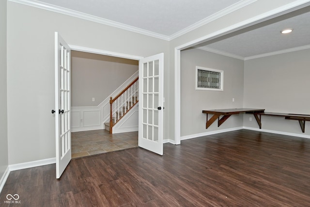 unfurnished room featuring wood finished floors, crown molding, stairway, and french doors