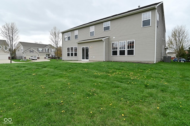 back of property with a lawn and central AC