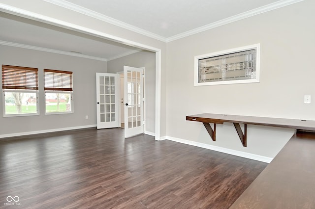 empty room featuring french doors, baseboards, dark wood-type flooring, and crown molding
