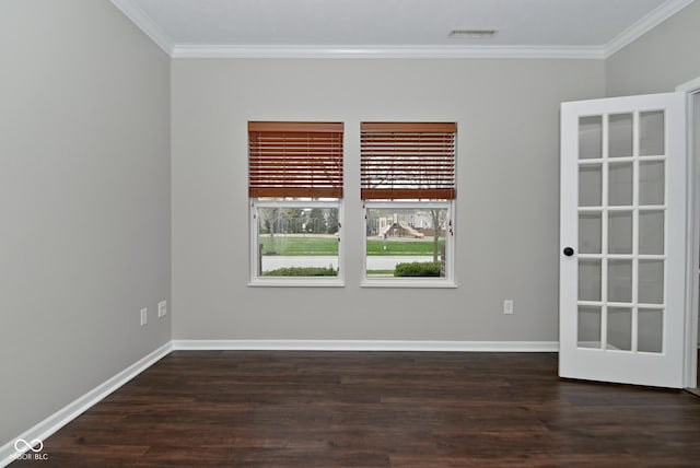 unfurnished room featuring wood finished floors, visible vents, baseboards, and ornamental molding