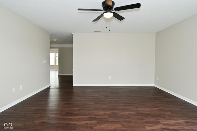 spare room featuring wood finished floors, a ceiling fan, baseboards, and visible vents