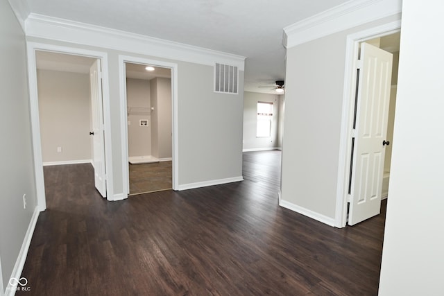 unfurnished room featuring baseboards, visible vents, ornamental molding, and dark wood finished floors