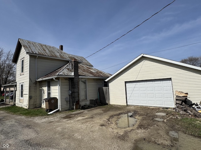 exterior space with an outbuilding and a garage
