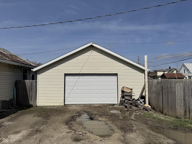 detached garage featuring fence