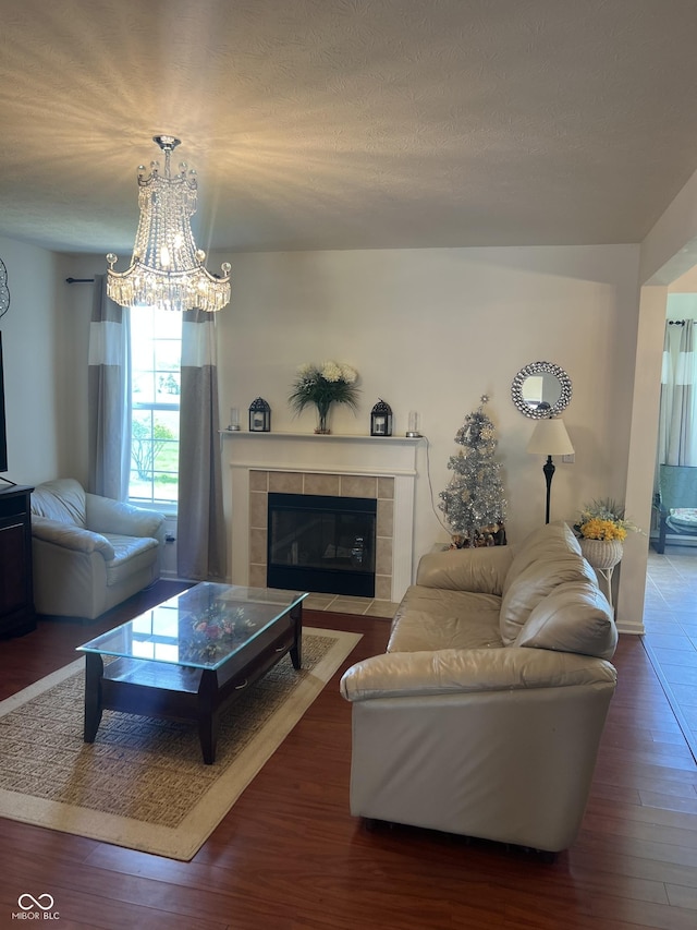 living area with a fireplace, wood finished floors, and a chandelier