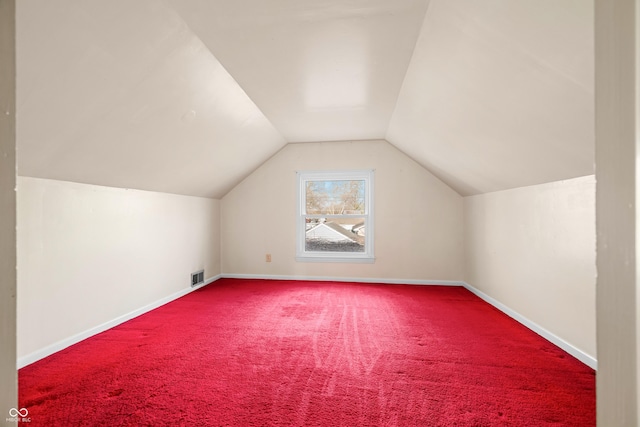 bonus room with carpet, visible vents, baseboards, and vaulted ceiling