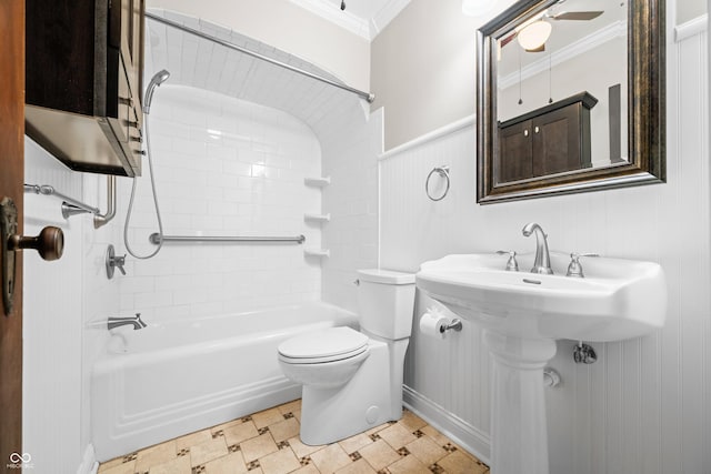 full bath featuring crown molding, toilet, shower / tub combination, and a wainscoted wall