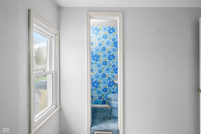 bathroom with toilet and visible vents
