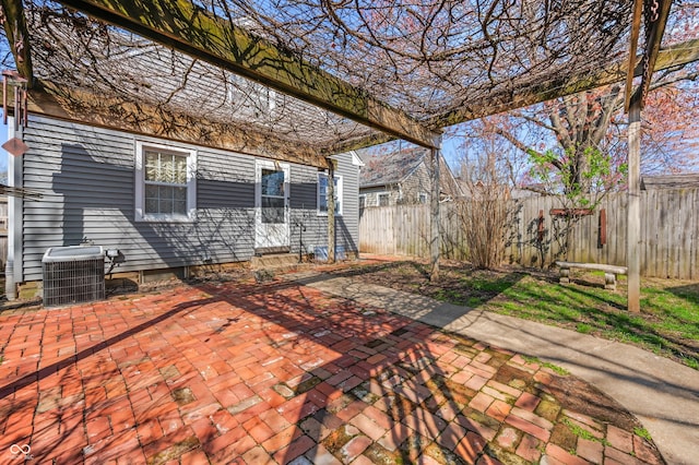 view of patio featuring cooling unit, entry steps, and fence