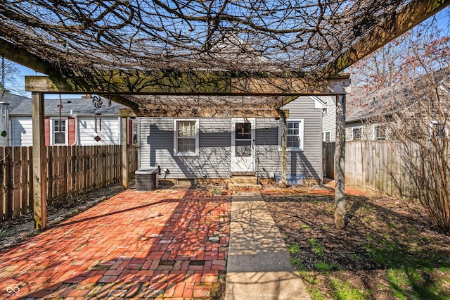exterior space with entry steps, a fenced backyard, and central AC unit