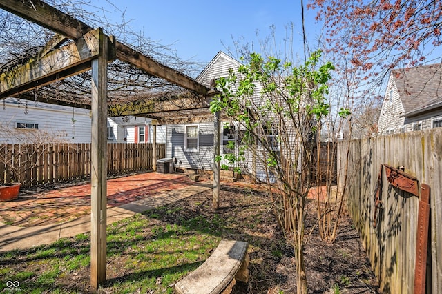 view of yard featuring a patio area, a fenced backyard, and central AC