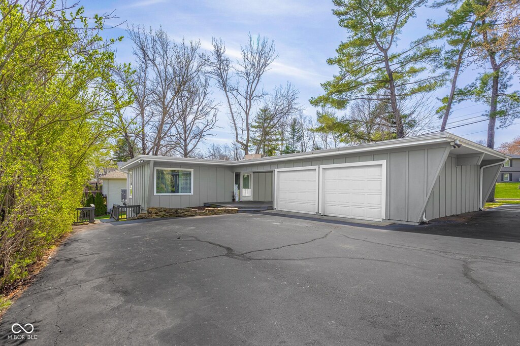 601 Terrace Lake Dr, Columbus, IN 47201 - view of front of house featuring board and batten siding, driveway, and an attached garage