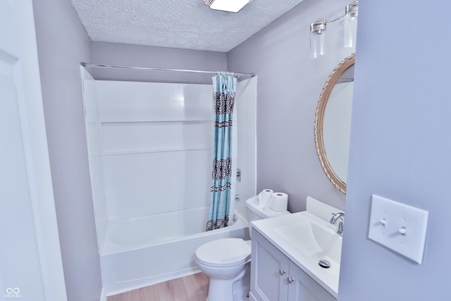full bath featuring a textured ceiling, shower / tub combo, toilet, wood finished floors, and vanity