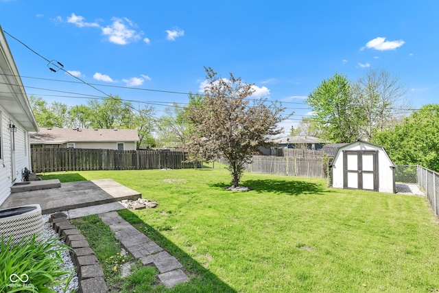 view of yard with a patio area, cooling unit, an outdoor structure, a fenced backyard, and a shed