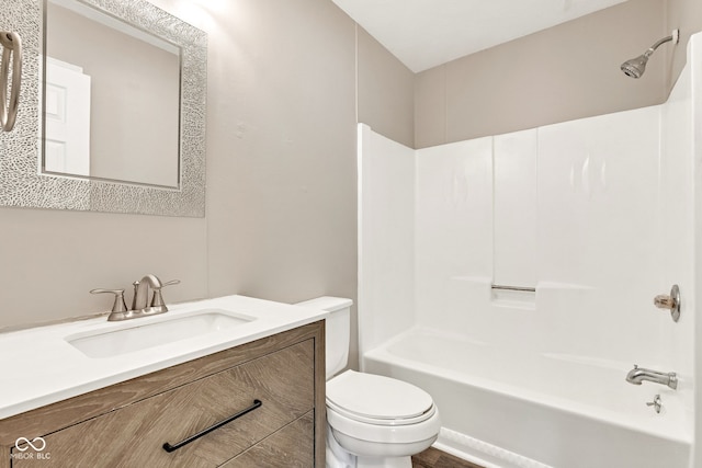 full bath featuring vanity, bathtub / shower combination, and toilet