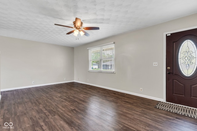 entryway featuring dark wood-style flooring, ceiling fan, and baseboards