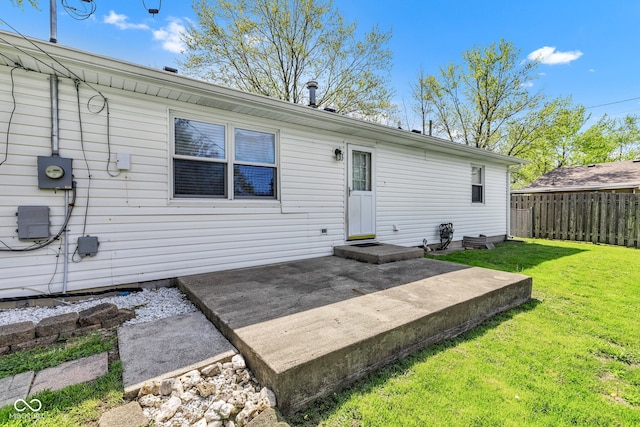 back of house with a lawn, fence, and a patio area