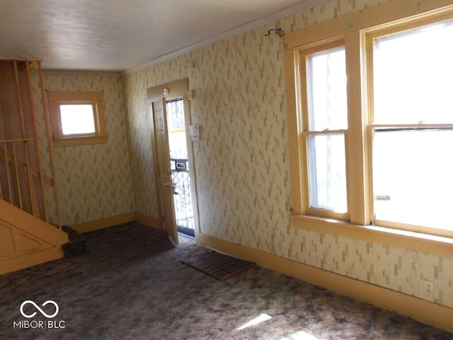 923 Woodview Blvd, Fort Wayne, IN 46806 - carpeted empty room featuring wallpapered walls, visible vents, ornamental molding, and a wealth of natural light