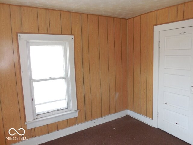 923 Woodview Blvd, Fort Wayne, IN 46806 - spare room featuring baseboards and wood walls