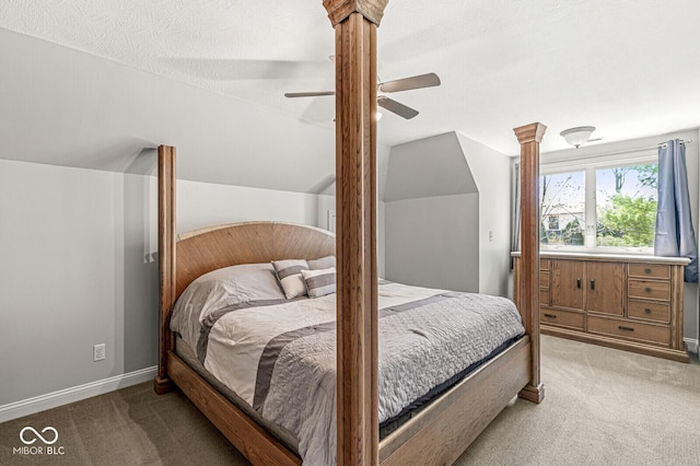 bedroom featuring a ceiling fan, vaulted ceiling, and carpet floors