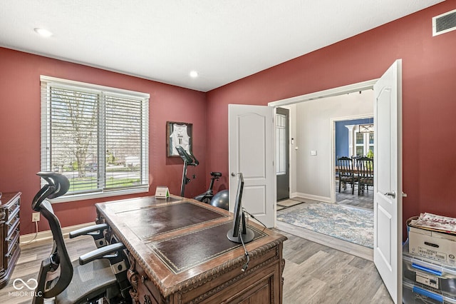 home office with baseboards, visible vents, light wood-style flooring, and recessed lighting