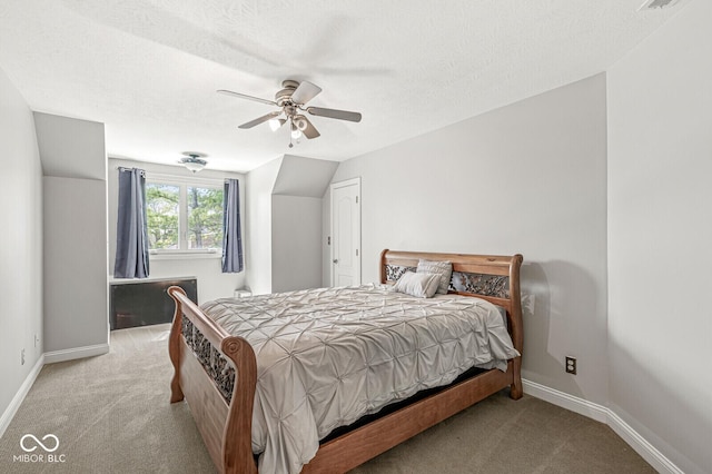 carpeted bedroom featuring baseboards, ceiling fan, and a textured ceiling