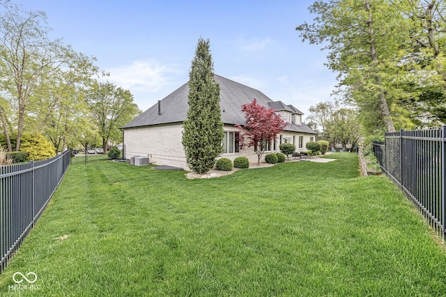 exterior space featuring central AC and a fenced backyard