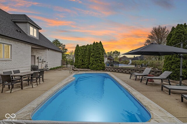 7259 Josiah Ct, Indianapolis, IN 46259 - pool at dusk featuring a patio area and an outdoor pool