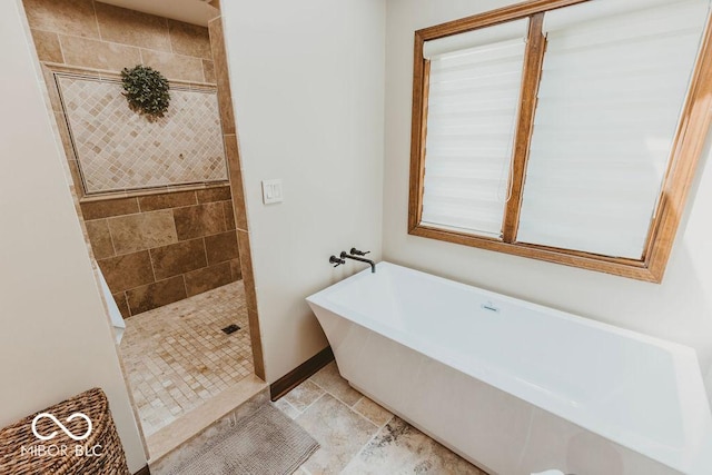 6712 Forrest Commons Blvd, Indianapolis, IN 46227 - bathroom featuring baseboards, a freestanding bath, and walk in shower