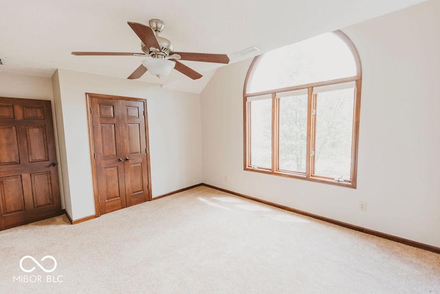 6712 Forrest Commons Blvd, Indianapolis, IN 46227 - unfurnished bedroom featuring baseboards, visible vents, lofted ceiling, and light colored carpet