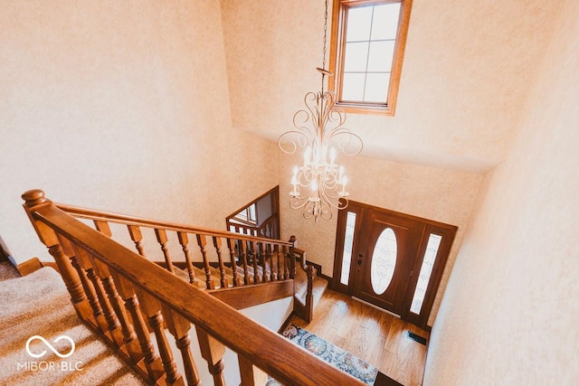 6712 Forrest Commons Blvd, Indianapolis, IN 46227 - entryway featuring a towering ceiling, a chandelier, wood finished floors, and stairway
