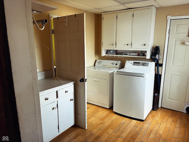 310 E Central Ave, Greensburg, IN 47240 - laundry area with washing machine and clothes dryer, cabinet space, and light wood finished floors