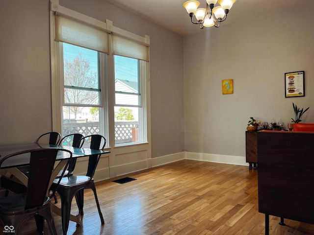 310 E Central Ave, Greensburg, IN 47240 - dining space featuring healthy amount of natural light, a chandelier, light wood-style floors, and baseboards