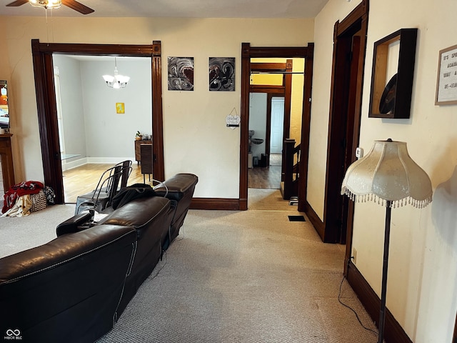 310 E Central Ave, Greensburg, IN 47240 - living area featuring light colored carpet, ceiling fan, baseboards, and a chandelier