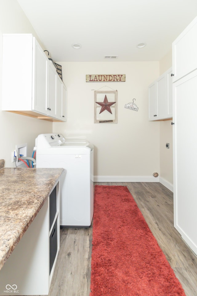 8267 W County Road 350 S, Shirley, IN 47384 - washroom featuring washer and clothes dryer, baseboards, light wood finished floors, visible vents, and cabinet space