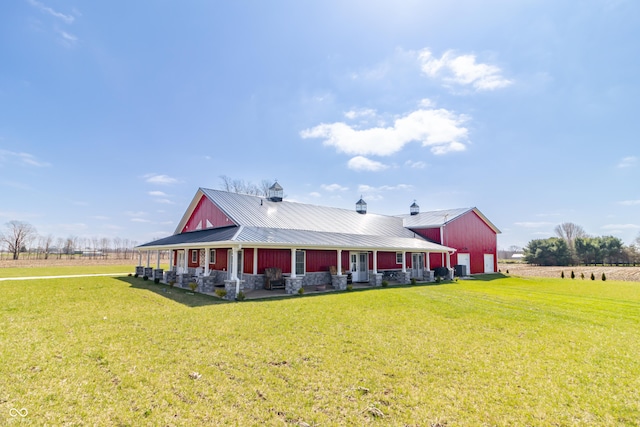 8267 W County Road 350 S, Shirley, IN 47384 - view of front of home with stone siding, metal roof, a chimney, a garage, and a front lawn