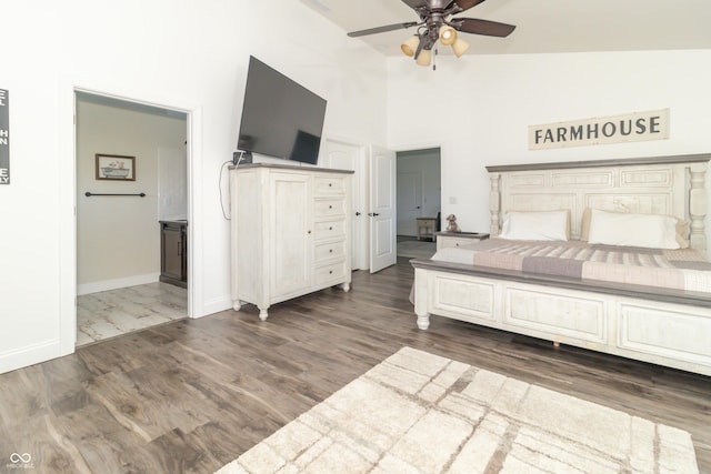 8267 W County Road 350 S, Shirley, IN 47384 - unfurnished bedroom with high vaulted ceiling, dark wood-type flooring, baseboards, and connected bathroom