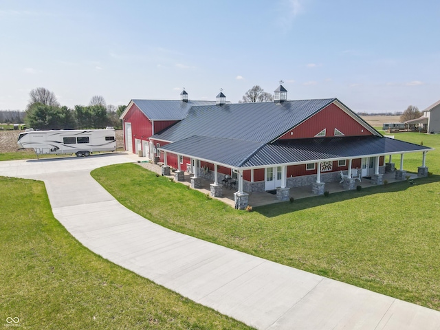 8267 W County Road 350 S, Shirley, IN 47384 - exterior space with driveway, stone siding, a front lawn, metal roof, and a garage