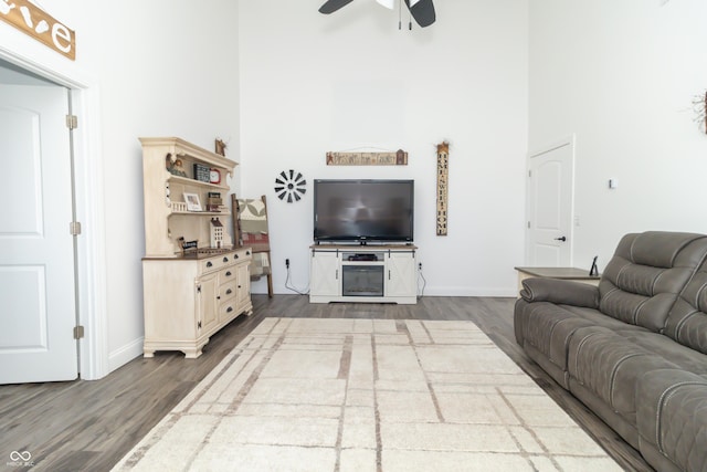 8267 W County Road 350 S, Shirley, IN 47384 - living room featuring a towering ceiling, baseboards, ceiling fan, and dark wood-type flooring