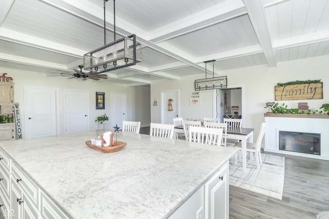 8267 W County Road 350 S, Shirley, IN 47384 - kitchen featuring light wood-type flooring, beamed ceiling, ceiling fan, white cabinets, and light stone countertops