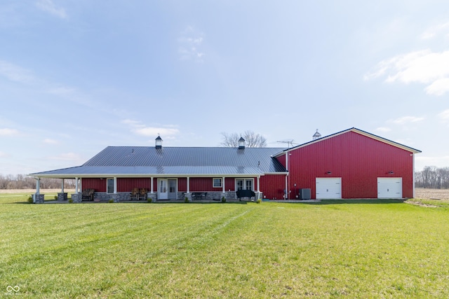 8267 W County Road 350 S, Shirley, IN 47384 - back of property featuring driveway, cooling unit, metal roof, a garage, and a yard