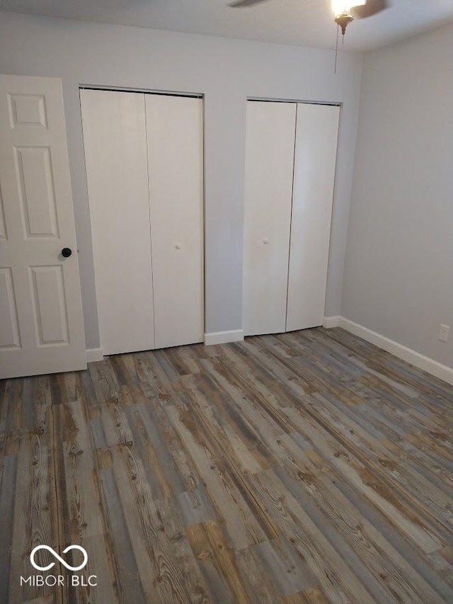 1447 Rebecca Ln, Franklin, IN 46131 - unfurnished bedroom featuring two closets and wood finished floors