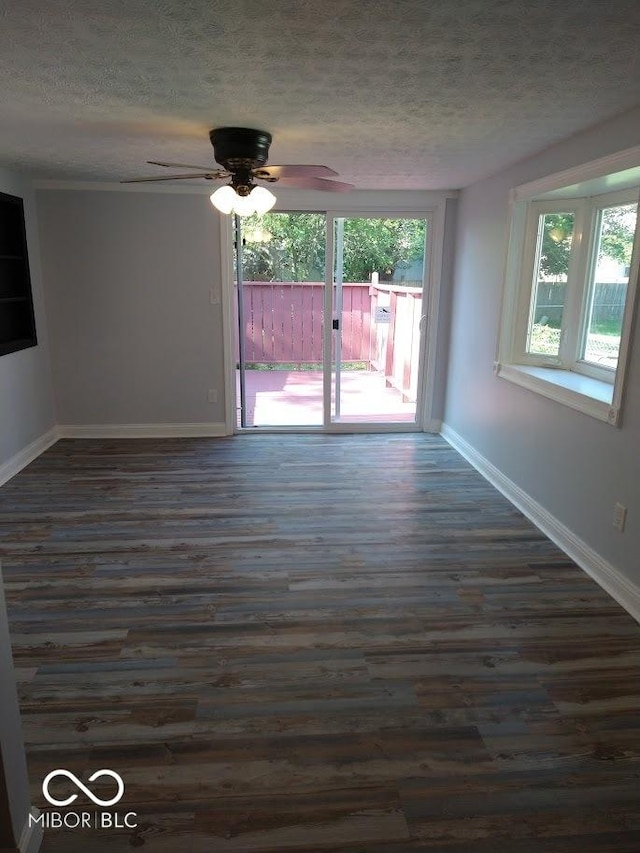 1447 Rebecca Ln, Franklin, IN 46131 - empty room featuring dark wood-style flooring, a textured ceiling, and ceiling fan