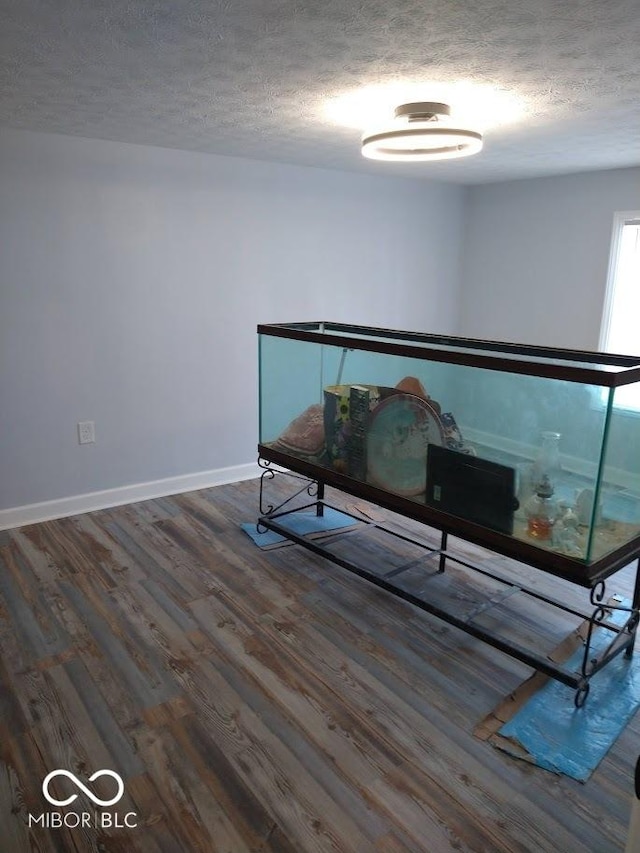 1447 Rebecca Ln, Franklin, IN 46131 - unfurnished bedroom with a textured ceiling and wood finished floors
