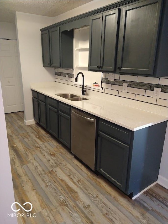 1447 Rebecca Ln, Franklin, IN 46131 - kitchen with stainless steel dishwasher, light wood-style flooring, light countertops, and decorative backsplash