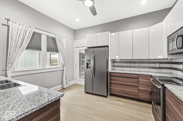 2006 Lexington Ave, Indianapolis, IN 46203 - kitchen with tasteful backsplash, modern cabinets, a ceiling fan, white cabinetry, and stainless steel appliances